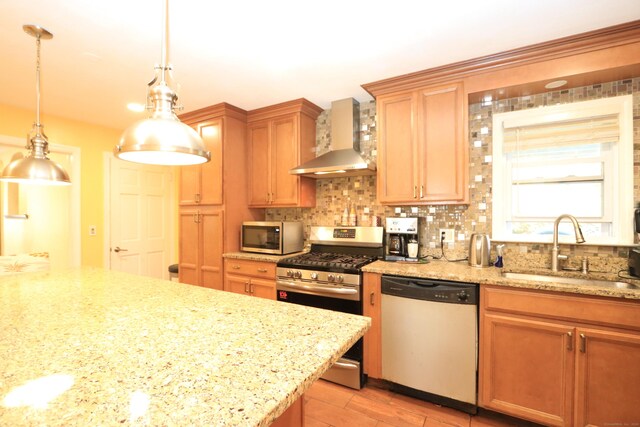 25 Muriel St, Norwalk, CT 06851 - kitchen featuring pendant lighting, wall chimney range hood, a sink, appliances with stainless steel finishes, and backsplash