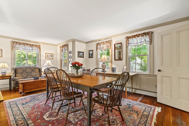 dining room with crown molding, baseboard heating, dark wood-type flooring, and plenty of natural light