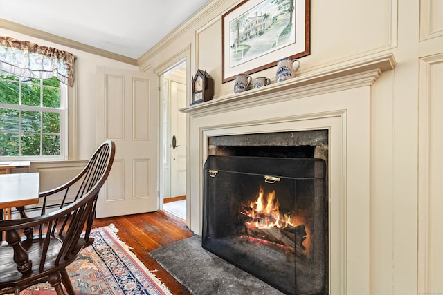 interior space with ornamental molding and hardwood / wood-style floors