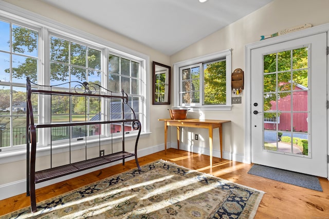 doorway featuring lofted ceiling and hardwood / wood-style floors