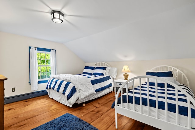 bedroom featuring a baseboard radiator, vaulted ceiling, and hardwood / wood-style flooring