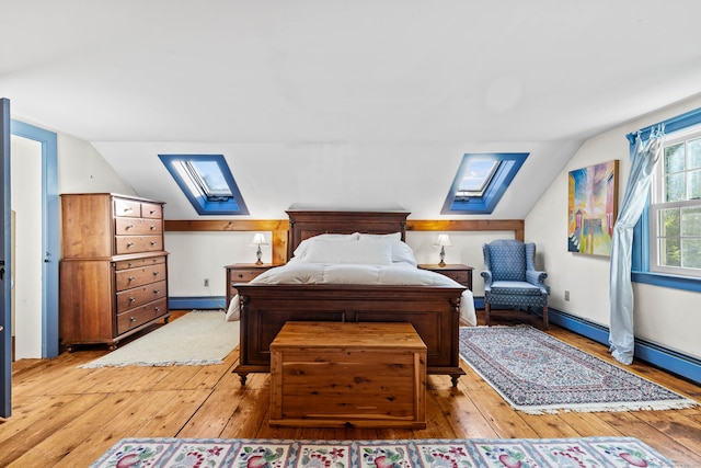 bedroom with light wood-type flooring, vaulted ceiling, and a baseboard radiator