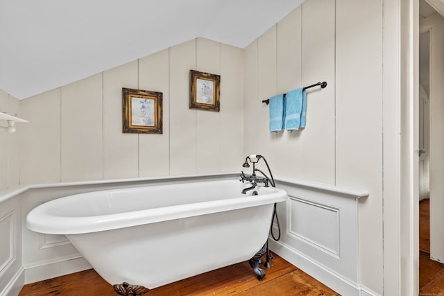 bathroom with wood-type flooring and a washtub