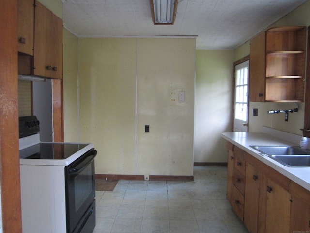 kitchen with white range with electric stovetop and sink