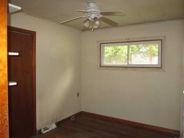 spare room with ornamental molding, dark hardwood / wood-style flooring, and ceiling fan