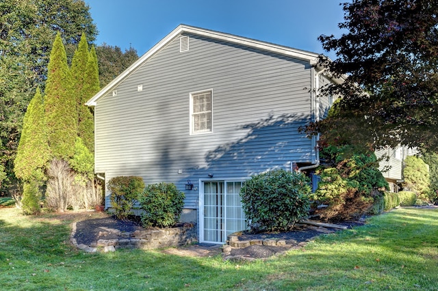 view of side of home with a lawn