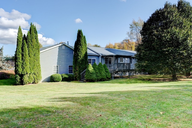 view of front of home with a front lawn and a deck