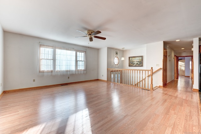 spare room with light hardwood / wood-style floors and ceiling fan