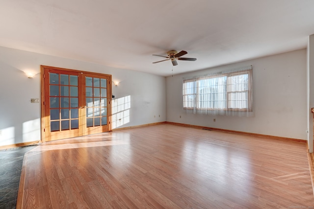 unfurnished room with french doors, light hardwood / wood-style flooring, and ceiling fan