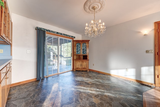 unfurnished dining area with a notable chandelier