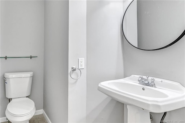 bathroom with sink, tile patterned floors, and toilet