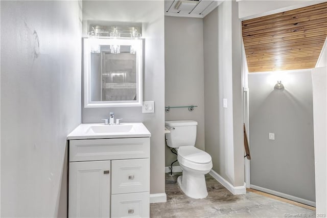 bathroom with wood ceiling, hardwood / wood-style flooring, vanity, and toilet