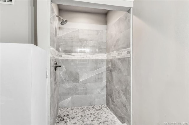 bathroom with a tile shower