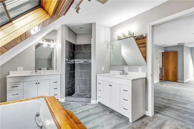 bathroom with independent shower and bath, vanity, and hardwood / wood-style flooring