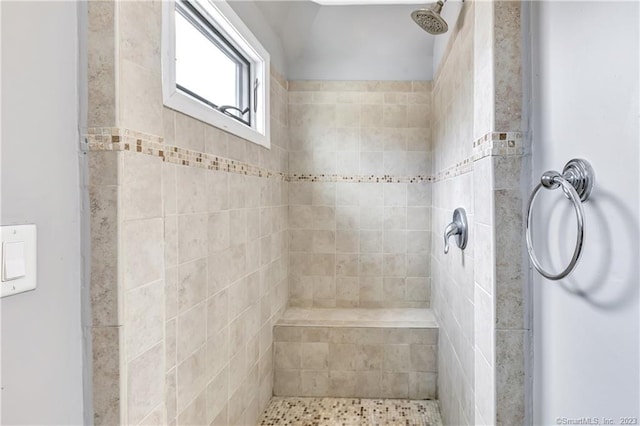 bathroom featuring tiled shower