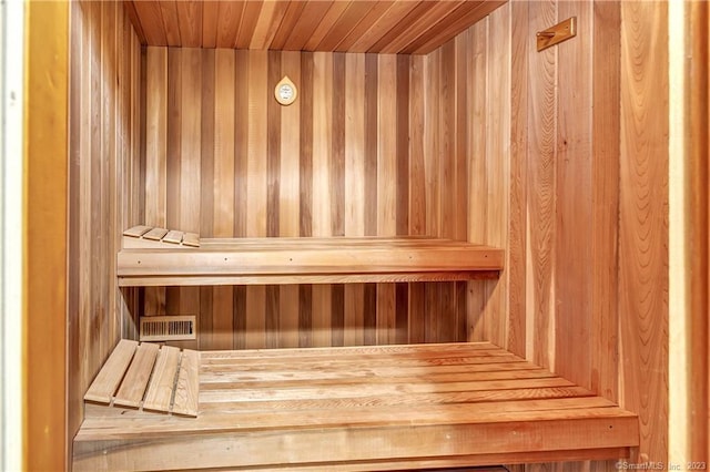 view of sauna with wood ceiling and wood walls