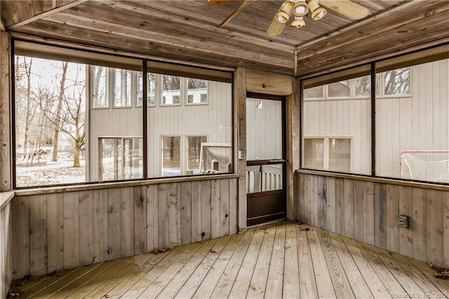 unfurnished sunroom with ceiling fan and wooden ceiling