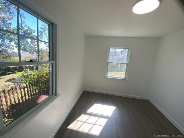 unfurnished room with wood finished floors and baseboards