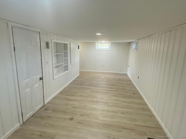 spare room with light wood-style floors and baseboards