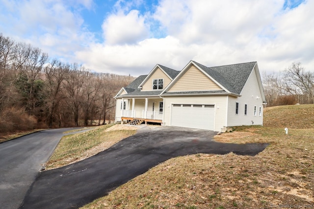 view of front of property featuring a porch and a garage