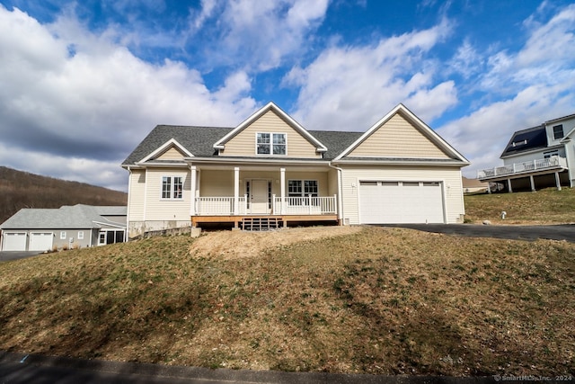 view of front of home featuring a garage, a front lawn, and a porch