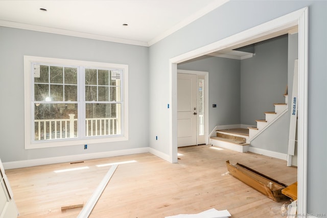 entrance foyer with light wood-type flooring and crown molding