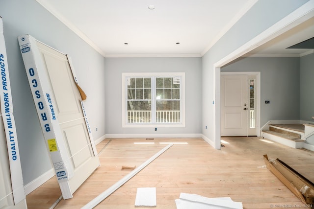 foyer with light hardwood / wood-style flooring and ornamental molding