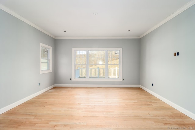 unfurnished room featuring crown molding and light hardwood / wood-style floors