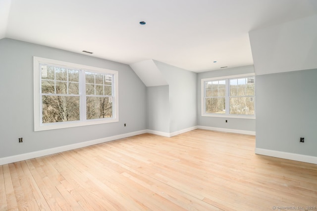 bonus room with light hardwood / wood-style flooring and vaulted ceiling