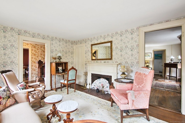 66 Artillery Rd, Middlebury, CT 06762 - living area featuring wood finished floors, wallpapered walls, and a fireplace with flush hearth