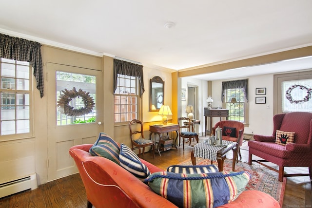 living room with crown molding, baseboard heating, and dark hardwood / wood-style flooring