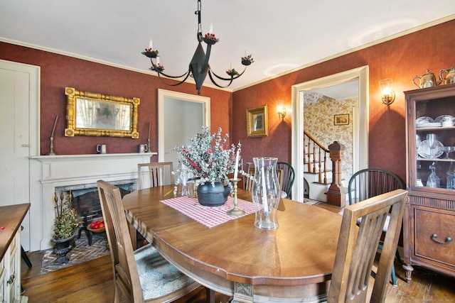 66 Artillery Rd, Middlebury, CT 06762 - dining room featuring wood finished floors, a chandelier, a fireplace with flush hearth, and crown molding