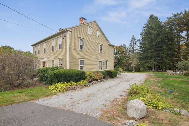66 Artillery Rd, Middlebury, CT 06762 - view of property exterior with a chimney and gravel driveway