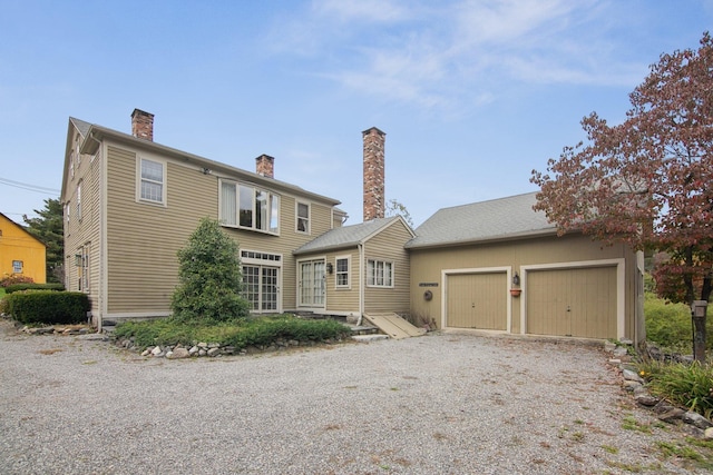66 Artillery Rd, Middlebury, CT 06762 - back of house featuring driveway, a chimney, and an attached garage