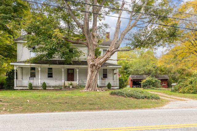 view of front of home featuring a front yard and covered porch