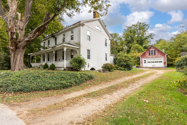 view of home's exterior featuring an outbuilding, a porch, and a garage