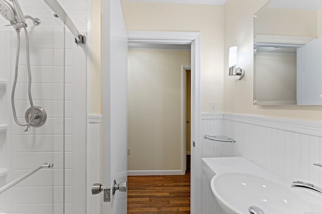 bathroom featuring wood-type flooring, an enclosed shower, and sink