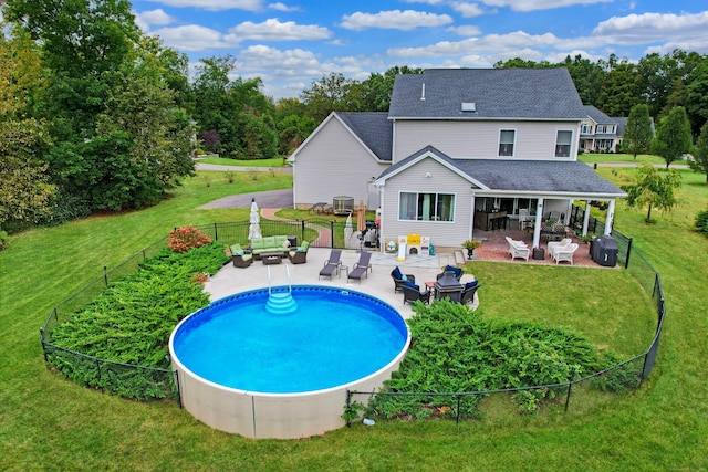 view of pool with a lawn, a patio area, and central AC