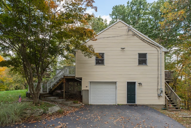 view of side of property with a deck and a garage