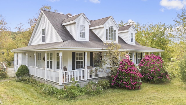 view of front facade with a front yard and covered porch