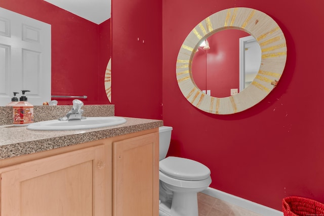 bathroom featuring tile patterned floors, vanity, and toilet