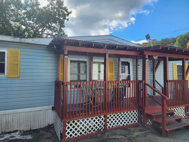 back of property featuring a deck