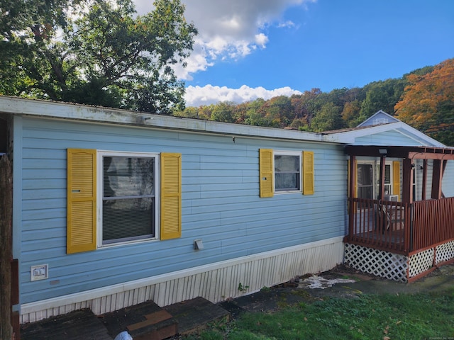 view of property exterior with a deck