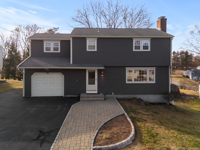 view of front of house with a garage and a front yard