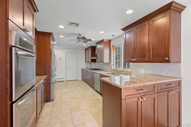 kitchen with sink, appliances with stainless steel finishes, ceiling fan, light stone countertops, and backsplash