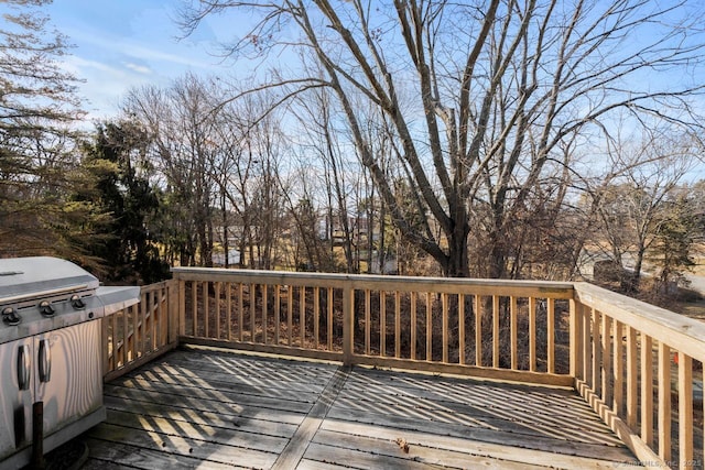 wooden terrace featuring a grill