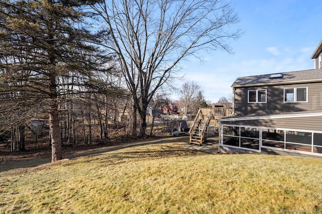 view of yard featuring a deck and a sunroom