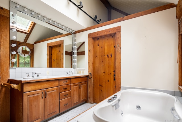 bathroom with vanity, vaulted ceiling with skylight, a tub to relax in, and wooden ceiling