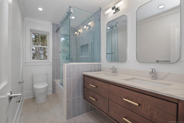 full bathroom with combined bath / shower with glass door, tile patterned floors, crown molding, toilet, and vanity