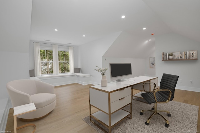 home office featuring vaulted ceiling and light hardwood / wood-style flooring